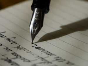 A person using a fountain pen to develop their language skills from digital learning