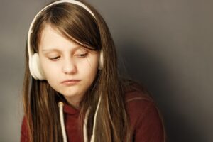 A teenage girl listening to music