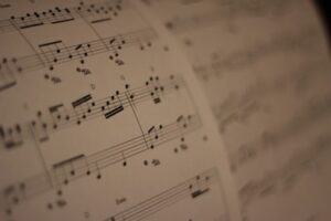 Reading sheet music for both Guitar and Piano