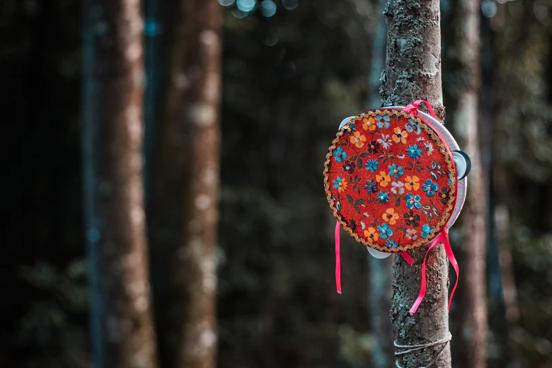 A colourful Tambourine with red flowery patterns on