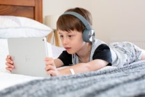 A child using an iPad for digital learning from home