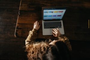 A child learning digitally through a laptop