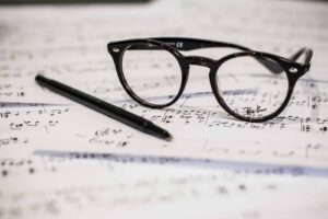 A pair of glasses resting on sheet music