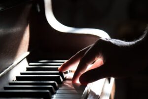 A close up of a person playing the piano