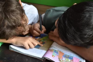 Two children reading and colouring in together