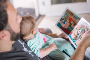 A father reading to his baby on his lap