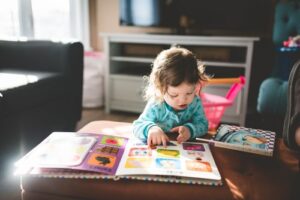 A young girl reading at home