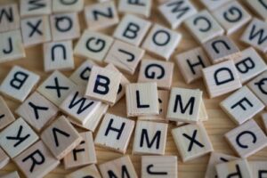 A series of mixed scrabble pieces on a table