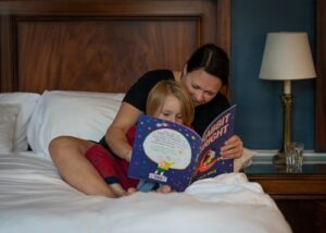 A mother and daughter reading together at bedtime