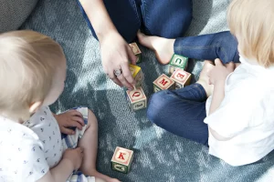 Young children playing with blocks with their parents