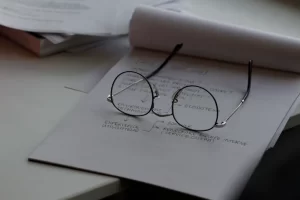 A pair glasses resting on a notepad