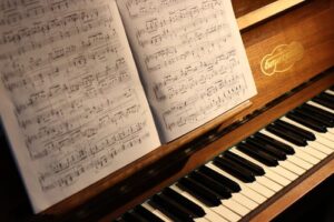 A close up of a piano with sheet music