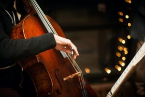 A man playing the cello in a band