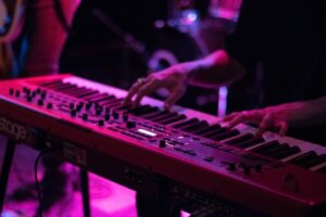 A person playing the keyboard in a club