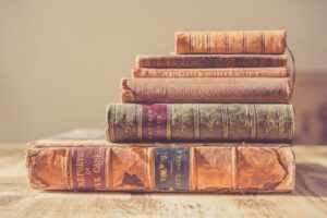 A stack of four old books