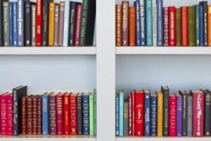 A white bookshelf with a row of books