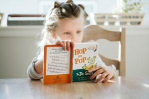 A child reading at the kitchen table