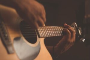 A close up of someone playing a guitar