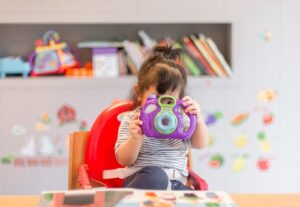 A child playing with a camera in class