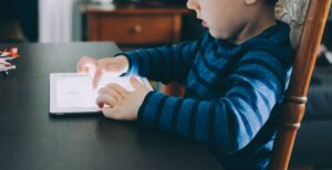 A child using edtech applications on an iPad from home