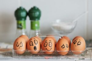 A load of eggs with painted faces on them