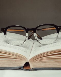 A pair of glasses resting on an open book