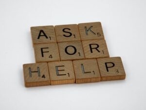 Ask for help spelled in scrabble pieces